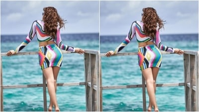Aamna decked up in a cropped top with full sleeves, a plunging neckline, bralette patterns and midriff-baring details. She teamed it with a multicoloured short bodycon skirt. (Instagram/@aamnasharifofficial)