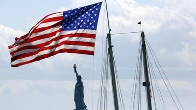 US Tourist Visa: United States flag flies near the Statue of Liberty in New York. (AP) US Tourist Visa: United States flag flies near the Statue of Liberty in New York. (AP)