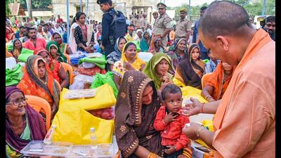 Uttar Pradesh chief minister Yogi Adityanath interacts with a child during the distribution of relief material to flood-affected people, in Gorakhpur district, Friday. (PTI Photo) Uttar Pradesh chief minister Yogi Adityanath interacts with a child during the distribution of relief material to flood-affected people, in Gorakhpur district, Friday. (PTI Photo)