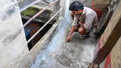 A resident shows the crack in his house due to the construction work for the East-West Metro tunnel in Bowbazar area of Kolkata on Friday. (PTI Photo)