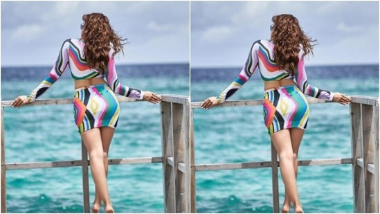 Aamna decked up in a cropped top with full sleeves, a plunging neckline, bralette patterns and midriff-baring details. She teamed it with a multicoloured short bodycon skirt.(Instagram/@aamnasharifofficial)
