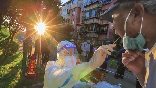 A health worker takes a swab sample from a man to be tested for the Covid-19 coronavirus in China's northern Tianjin, August 31.&nbsp;(AFP)