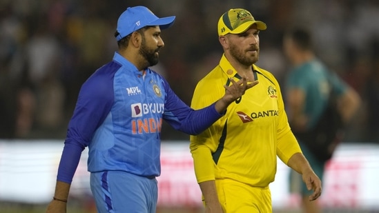India's captain Rohit Sharma, left, interacts with Australian captain Aaron Finch as they leave the field after the toss (AP)