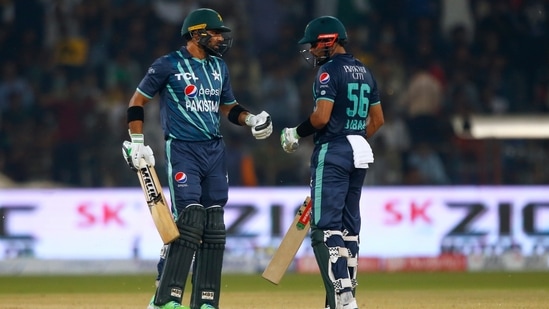 Pakistan's Iftikhar Ahmed, left, celebrates with batting partner Babar Azam&nbsp;(AP)