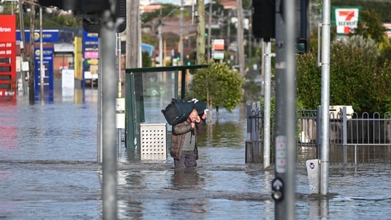 A man wades through floodwaters amidst evacuation orders in the Maribyrnong suburb of Melbourne, Australia, Friday.(via REUTERS)
