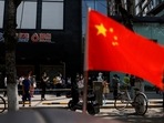 China-Taiwan Conflict: A China's flag flutters near people lining up to get tested at a makeshift nucleic acid testing site.&nbsp;