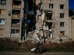 A local resident pulls a cart past a damaged building in the town of Bakhmut amid the Russian invasion of Ukraine. (Photo by Dimitar DILKOFF / AFP) A local resident pulls a cart past a damaged building in the town of Bakhmut amid the Russian invasion of Ukraine. (Photo by Dimitar DILKOFF / AFP)