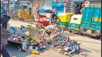Garbage dumped on a road in the Nabi Karim area of Paharganj. (HT Photo)