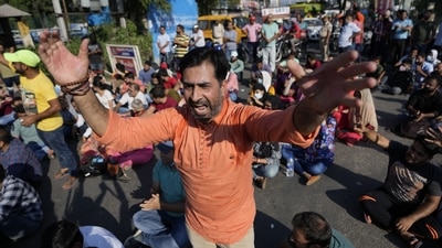 A man raises slogans during a protest in Jammu on Saturday. (AP) A man raises slogans during a protest in Jammu on Saturday. (AP)