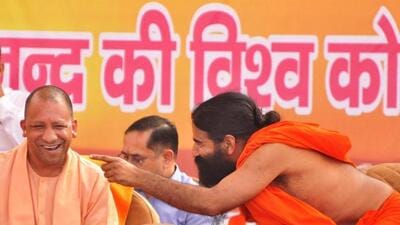 Uttar Pradesh chief minister Yogi Adityanath and yoga guru Baba Ramdev at a programme in Moradabad on Saturday. (PTI PHOTO)