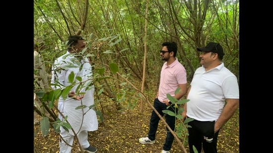 Sagar Setia (pink t-shirt), at one of the Miyawaki forest set up in just 14 months at a village in Fazilka . (HT photo)