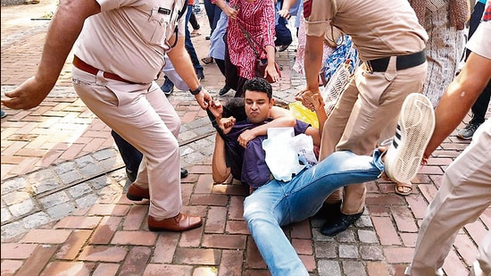 Delhi Police personnel remove AISA activists protesting at the Delhi University’s Arts Faculty. (PTI)