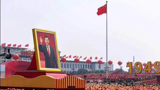 A float with a giant portrait of China's President Xi Jinping passes by Tiananmen Square during the National Day parade in Beijing, on October 1, 2019. Xi is widely expected to secure a third term as president at the Chinese Communist Party congress meeting starting on October 16, 2022, upending the succession norms that Chinese leaders have abided by since the 1990s. (AFP)