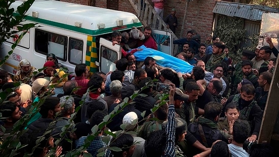 People carry the body of Puran Krishan Bhat in Shopian district on Saturday,(AP)