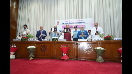 Chandigarh administrator Banwarilal Purohit releasing a book on breast cancer management at PGIMER on Saturday. (HT Photo)