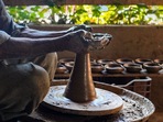 Srinagar: Father of potter Mohammad Umar Kumar moulds an earthen lamp on a wheel, ahead of Diwali festival, at his workshop at Eishbar, Nishat in Srinagar, Saturday,&nbsp;