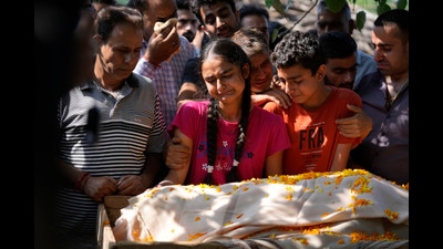 The distraught daughter and son during the funeral of Puran Krishan Bhat in Jammu on Sunday. Bhat was shot dead at his home in Shopian district on Saturday. (AP) The distraught daughter and son during the funeral of Puran Krishan Bhat in Jammu on Sunday. Bhat was shot dead at his home in Shopian district on Saturday. (AP)