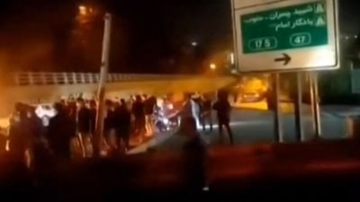 Iran Evin Prison Fire :This image grab reportedly shows Iranian protesters gathered on a road leading to the Evin prison, in the northwest of the Iranian capital Tehran. (AFP) Iran Evin Prison Fire :This image grab reportedly shows Iranian protesters gathered on a road leading to the Evin prison, in the northwest of the Iranian capital Tehran. (AFP)
