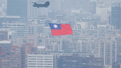 China-Taiwan Conflict: A Chinook helicopter carrying a Taiwan flag flies over the city during the country's National Day celebration in Taipei, Taiwan. (Reuters)