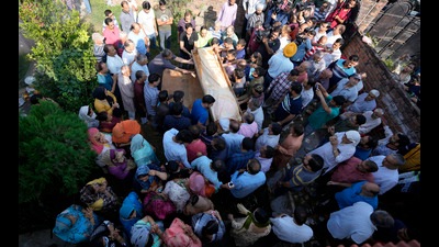 Relatives carry the body of Puran Krishan Bhat in Jammu on Sunday. Bhat, was shot dead at his home in Shopian district. (AP)