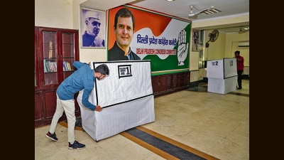 Congress workers prepare for the election of the party's new president in New Delhi on Sunday. (PTI) Congress workers prepare for the election of the party's new president in New Delhi on Sunday. (PTI)