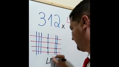 The image, taken from the viral video, shows the man solving a simple math question with the help of a trick. (Twitter/@TansuYegen) The image, taken from the viral video, shows the man solving a simple math question with the help of a trick. (Twitter/@TansuYegen)