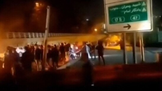 Iran Evin Prison Fire :This image grab reportedly shows Iranian protesters gathered on a road leading to the Evin prison, in the northwest of the Iranian capital Tehran.&nbsp;(AFP)
