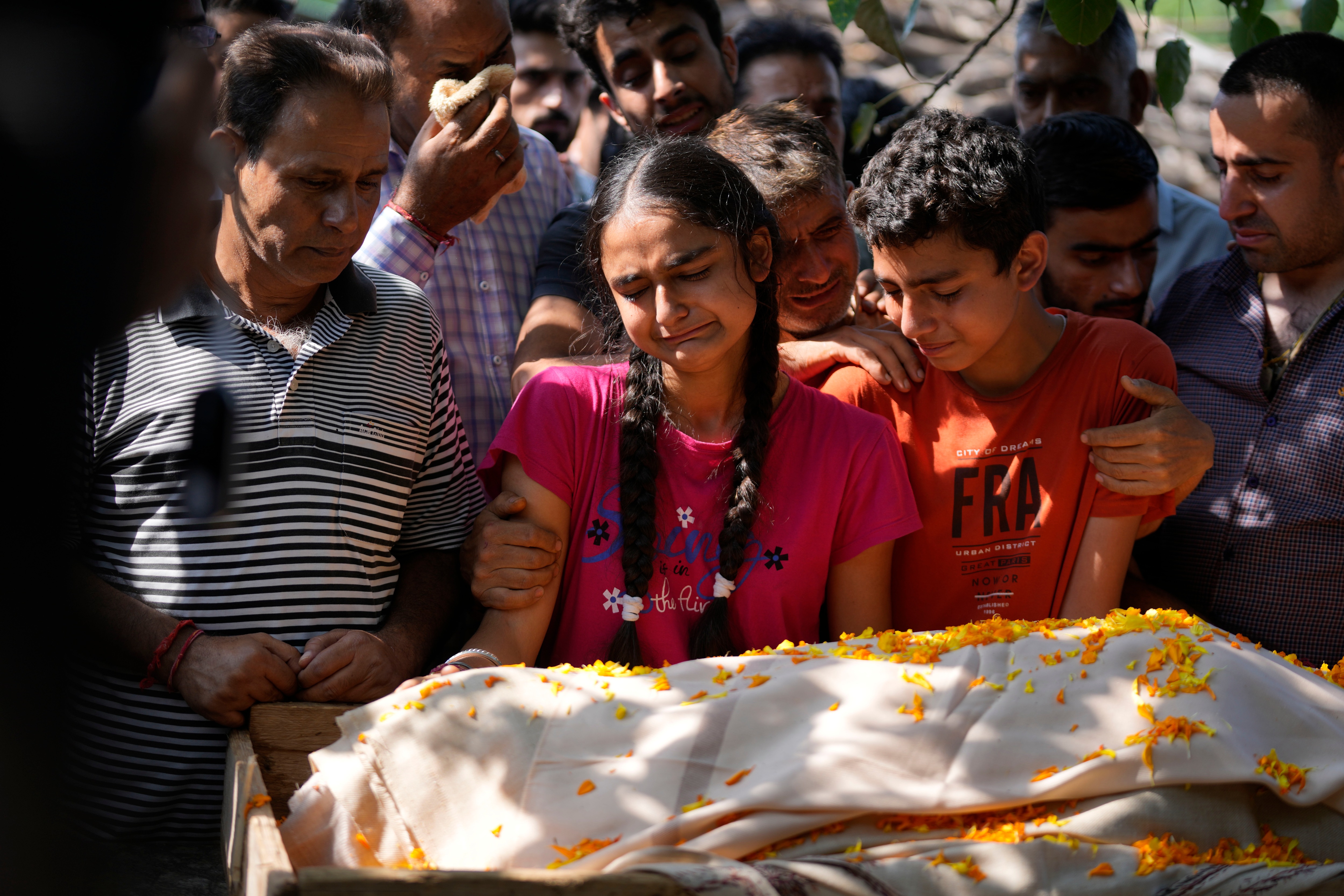 The distraught daughter and son during the funeral of Puran Krishan Bhat in Jammu on Sunday. Bhat was shot dead at his home in Shopian district on Saturday.&nbsp; (AP)