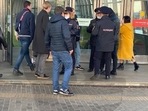 Russia-Ukraine War: Men stopped outside metro station entrances.