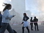 Russia-Ukraine War: Local residents walk past police officers after a drone attack in Kyiv.