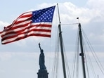 US Visa: A United States flag near the Statue of Liberty in New York. US Visa: A United States flag near the Statue of Liberty in New York.