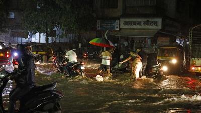 Vehicle users on a waterlogged road at Bibwewadi, on Monday. (RAHUL RAUT/HT)