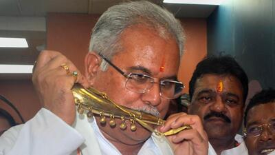 Chhattisgarh chief minister Bhupesh Baghel tries a traditional instrument during inauguration of a C-Mart, at Jagdalpur in Bastar district (PTI File Photo) Chhattisgarh chief minister Bhupesh Baghel tries a traditional instrument during inauguration of a C-Mart, at Jagdalpur in Bastar district (PTI File Photo)