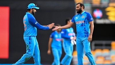 Indian captain Rohit Sharma, left, gestures to teammate Mohammed Shami following the ICC T20 World Cup warm-up cricket match between Australia and India at the Gabba (AP)