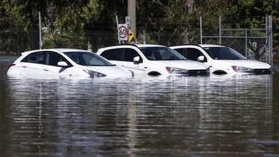Australia Floods: A trio of cars are stuck in floodwaters. (AP) Australia Floods: A trio of cars are stuck in floodwaters. (AP)