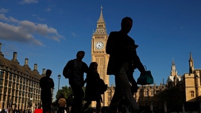 Pedestrians walk past the Elizabeth Tower, more commonly known as Big Ben for the bell inside the tower's clock, at the the Houses of Parliament in central London. (AFP)