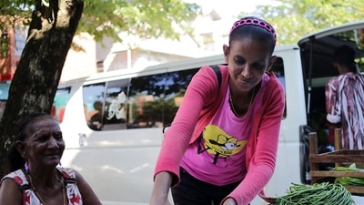 Surinamese Gaytrie Bhaero arranges vegetables on her street stall at the Jodenbreestraat in Paramaribo, on September 15, 2022. (Photo by Ranu Abhelakh / AFP) (AFP)