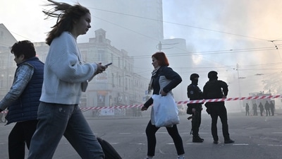Russia-Ukraine War: Local residents walk past police officers after a drone attack in Kyiv. (AFP)