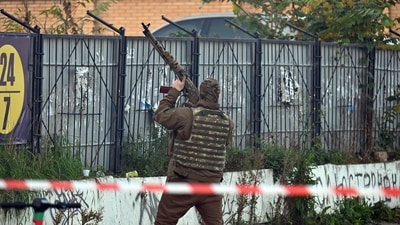 Russia-Ukraine War: A Ukrainian serviceman attempts to shoot down a drone during an attack in Kyiv. (AFP)