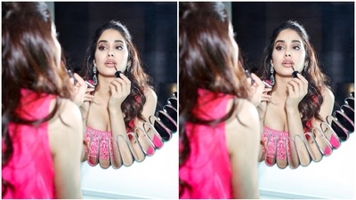 Janhvi's outfit features a cropped blouse with spaghetti straps, a plunging square neckline, a midriff-baring hem, and intricate dori embroidery done in a contrasting white shade. She wore it with matching bright pink sharara pants. They have a high-rise waistline, flared hem, and similar dori embroidery. (Instagram) Janhvi's outfit features a cropped blouse with spaghetti straps, a plunging square neckline, a midriff-baring hem, and intricate dori embroidery done in a contrasting white shade. She wore it with matching bright pink sharara pants. They have a high-rise waistline, flared hem, and similar dori embroidery. (Instagram)