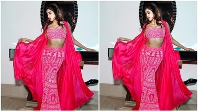Janhvi completed her ensemble with a rani pink-coloured georgette cape jacket. The sleeveless drape features a long and asymmetrical hem length, floral threadwork on the borders, and an open front. (Instagram) Janhvi completed her ensemble with a rani pink-coloured georgette cape jacket. The sleeveless drape features a long and asymmetrical hem length, floral threadwork on the borders, and an open front. (Instagram)