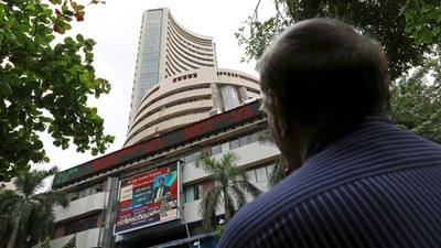 A man looks at a screen across a road displaying the Sensex on the facade of the Bombay Stock Exchange (BSE) building in Mumbai. (REUTERS)