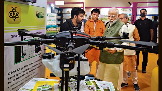 Prime Minister Narendra Modi inspects the products on display at the inauguration of PM Kisan Samman Sammelan 2022, in New Delhi on Monday. (PTI)
