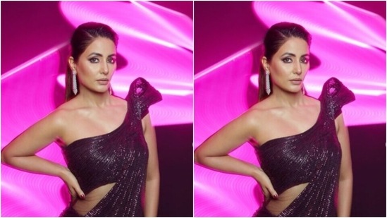 Hina’s attire featured maroon shimmery blouse with sequin details and off shoulder details. The blouse also came with a dramatic shoulder short cape in one shoulder.(Instagram/@realhinakhan)