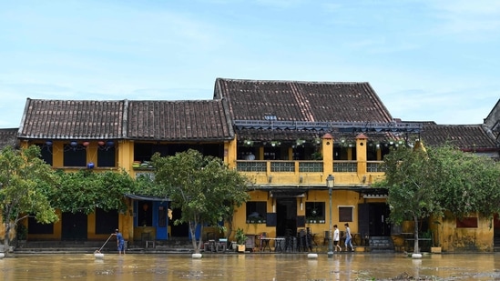 Typhoon Nesat: People walk on a flooded street.(AFP)