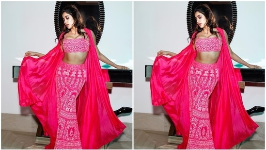 Janhvi completed her ensemble with a rani pink-coloured georgette cape jacket. The sleeveless drape features a long and asymmetrical hem length, floral threadwork on the borders, and an open front.(Instagram)