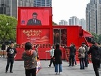 People watch a screen showing China's President Xi Jinping speaking during the opening session of the Chinese Communist Party's Congress in Shanghai. (AFP) People watch a screen showing China's President Xi Jinping speaking during the opening session of the Chinese Communist Party's Congress in Shanghai. (AFP)