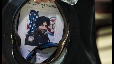 A Houston Police officer places a picture of Harris County Sheriff’s Deputy Sandeep Dhaliwal in his hat during the deputy’s funeral at Berry Center on Oct. 2, 2019, in Houston. A man was convicted of capital murder on Monday, Oct. 17, 2022, in the 2019 shooting death of the law enforcement officer who was the first Sikh deputy in his Texas agency. (AP, File)