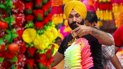 A customer looks at decorative items displayed for sale at a shop ahead of the Diwali festival in Amritsar. (PTI)