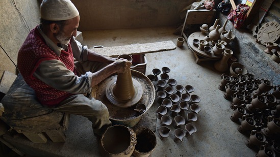 Abdul Salam Kumar, a Kashmiri Muslim potter makes earthen lamps at his home workshop ahead of Diwali, on the outskirts of Srinagar.(HT Photo/Waseem Andrabi)